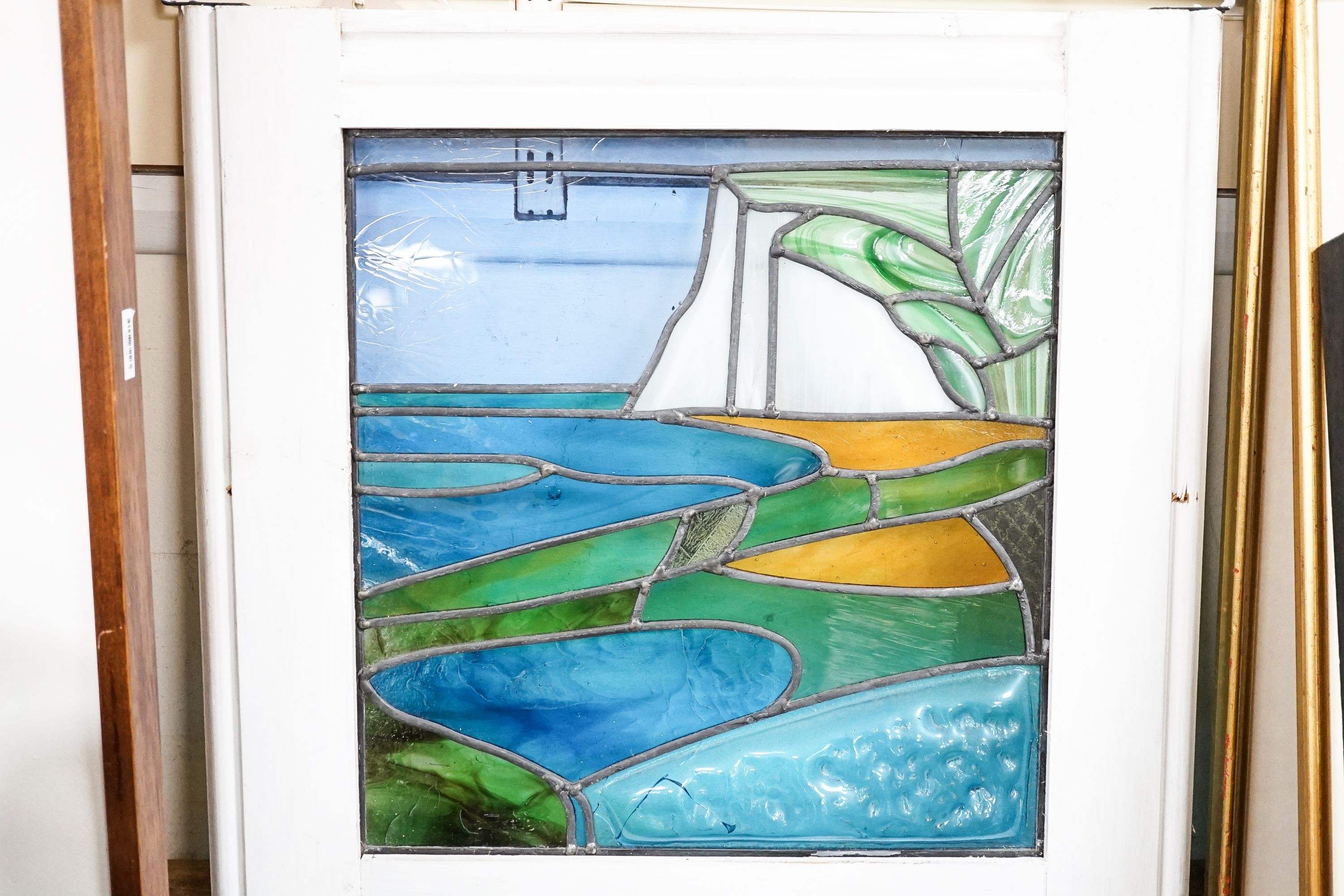 A stained glass framed panel, 'Cuckmere Haven including The Seven Sisters', height overall 52cm